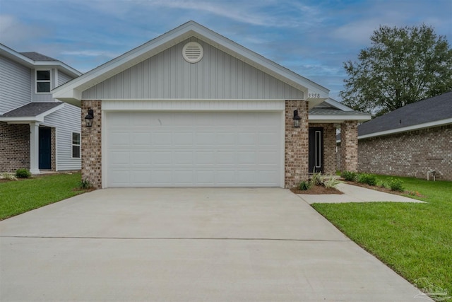 ranch-style home featuring a garage, a front lawn, brick siding, and driveway