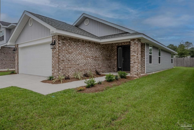 view of front of home featuring a front lawn, concrete driveway, an attached garage, a shingled roof, and brick siding