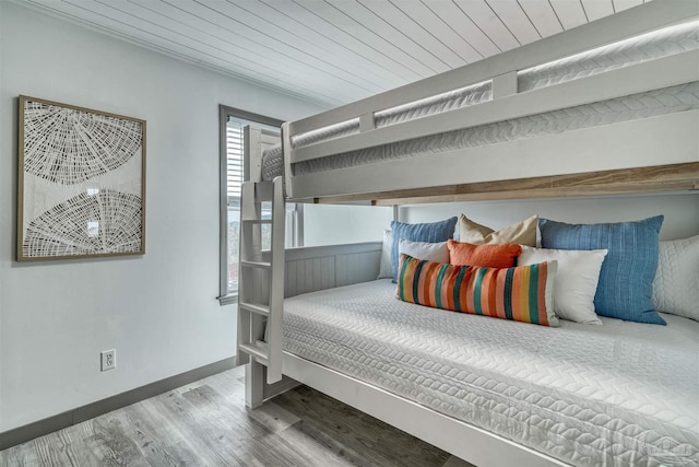 bedroom featuring hardwood / wood-style floors and wooden ceiling