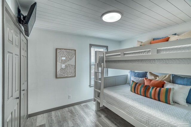 bedroom featuring hardwood / wood-style floors and wooden ceiling