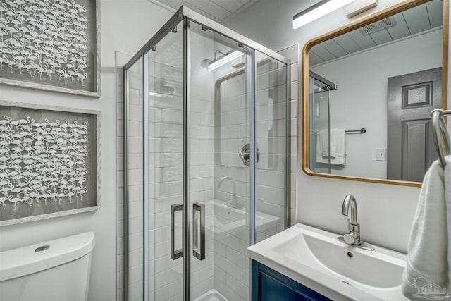 bathroom featuring walk in shower, vanity, and toilet