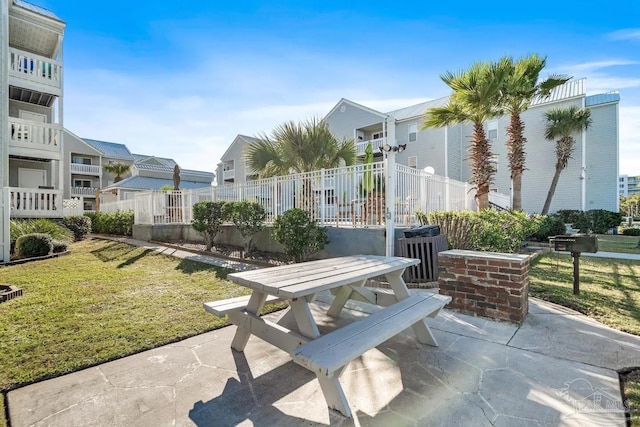 view of community featuring a yard and a patio area