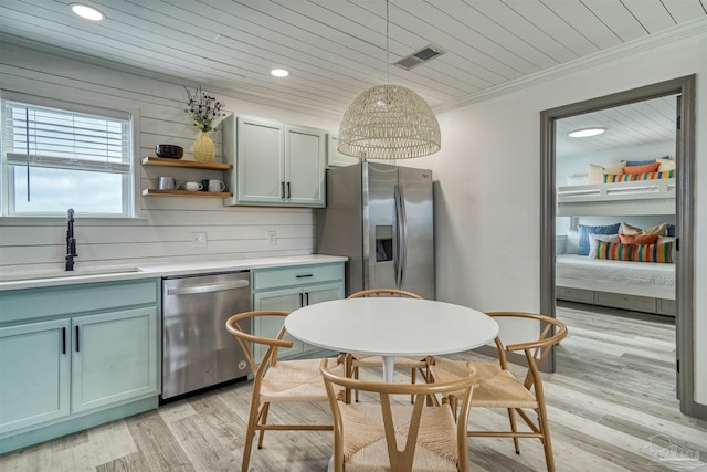 kitchen featuring light wood-type flooring, appliances with stainless steel finishes, wood ceiling, sink, and hanging light fixtures