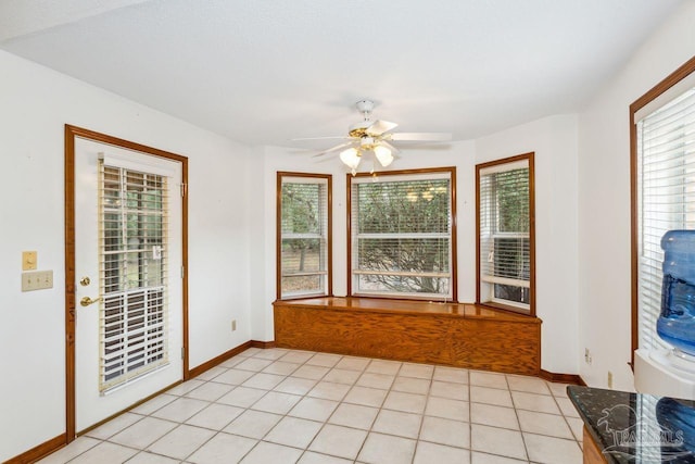 interior space with a wealth of natural light, ceiling fan, and light tile patterned floors