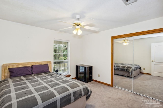 carpeted bedroom featuring a closet, a textured ceiling, and ceiling fan