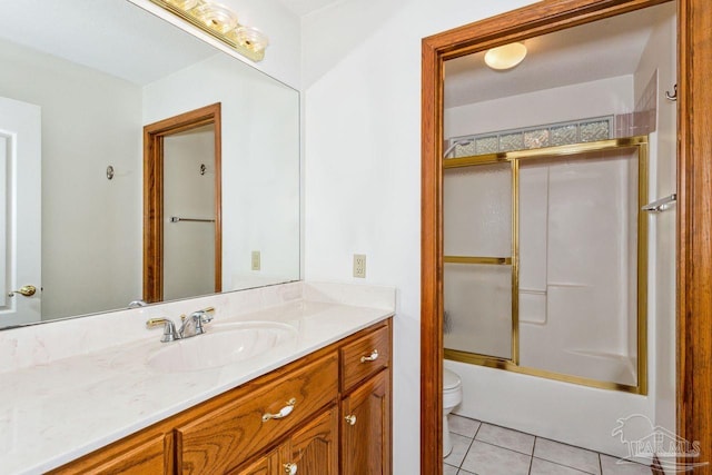 full bathroom with toilet, shower / bath combination with glass door, tile patterned floors, and vanity