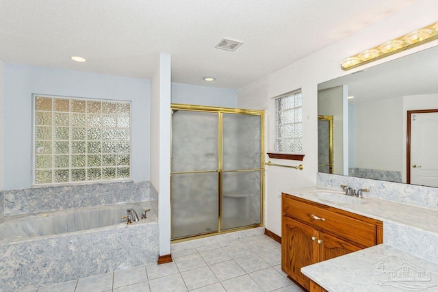 bathroom featuring independent shower and bath, vanity, a textured ceiling, and tile patterned floors