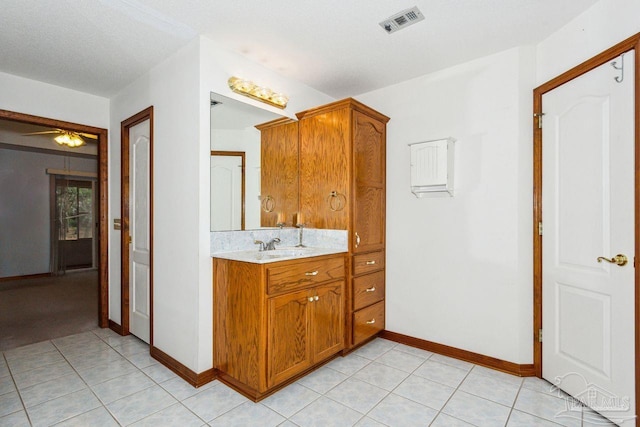 bathroom with vanity, ceiling fan, tile patterned flooring, and a textured ceiling