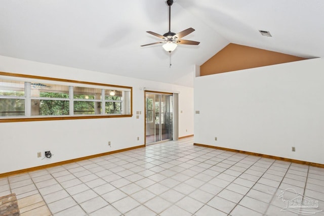 tiled empty room with ceiling fan and vaulted ceiling