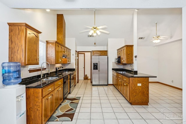 kitchen featuring sink, tasteful backsplash, high vaulted ceiling, light tile patterned flooring, and appliances with stainless steel finishes