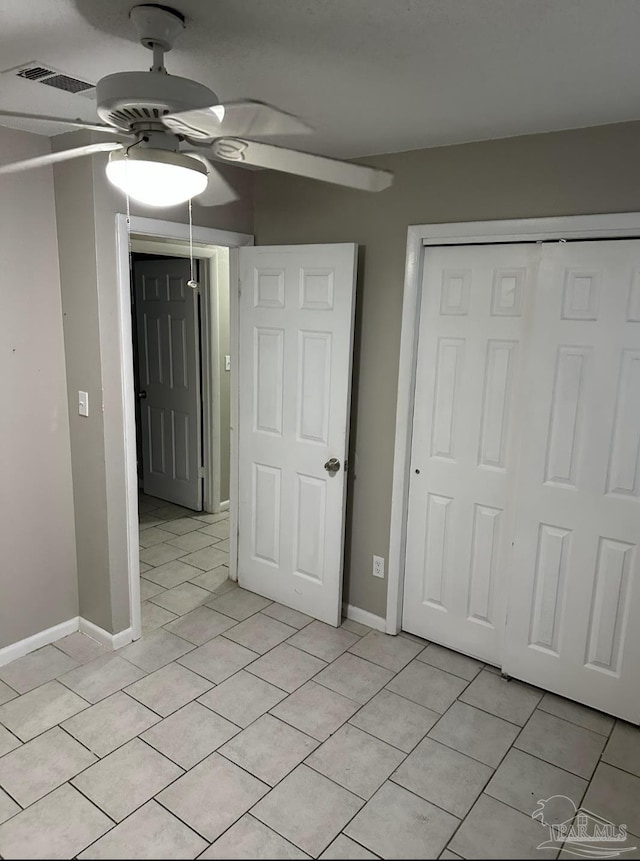 907 Colbert Ave, Pensacola, FL 32507 - unfurnished bedroom featuring light tile patterned flooring, a closet, and ceiling fan