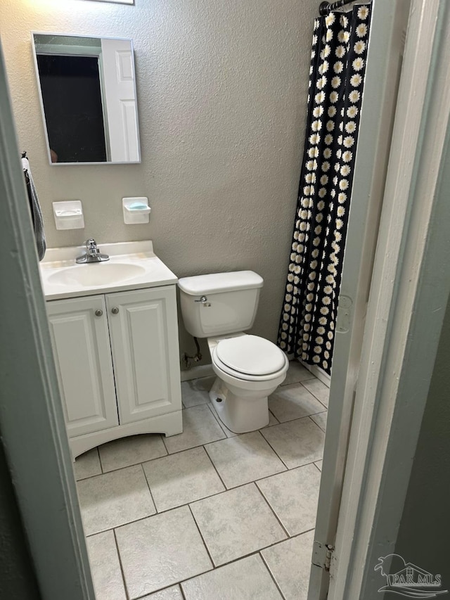 907 Colbert Ave, Pensacola, FL 32507 - bathroom featuring vanity, tile patterned floors, and a textured wall