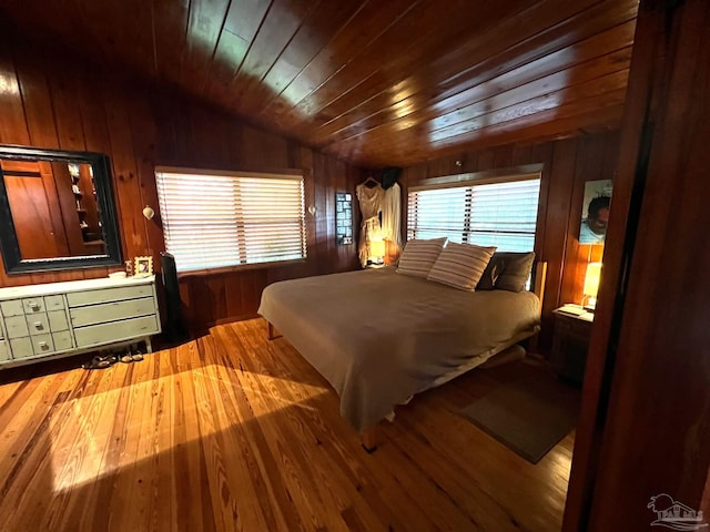 bedroom with light hardwood / wood-style flooring, lofted ceiling, and wood ceiling