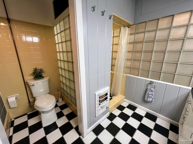 bathroom with walk in shower, tile walls, toilet, and heating unit