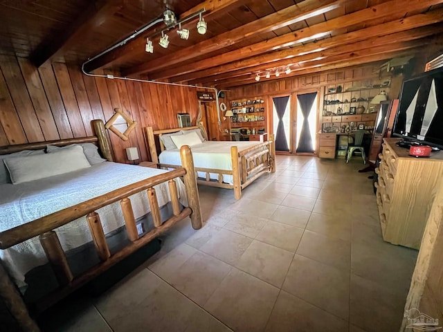 bedroom featuring beamed ceiling, wood ceiling, wooden walls, and light tile patterned floors