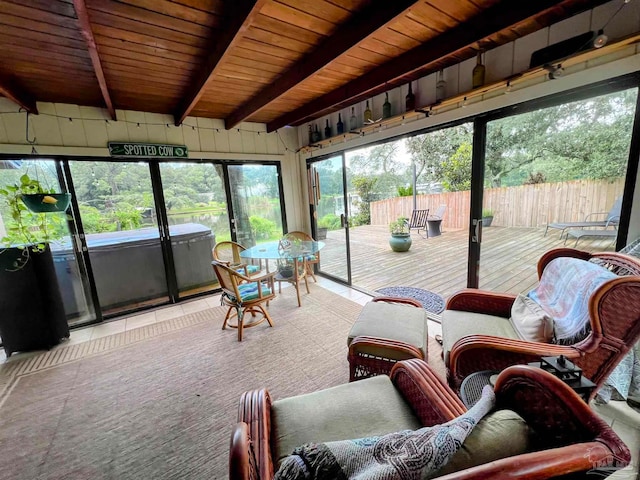 sunroom featuring beam ceiling and wood ceiling