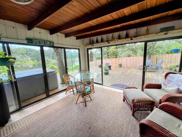 sunroom / solarium featuring a water view, beamed ceiling, and wooden ceiling