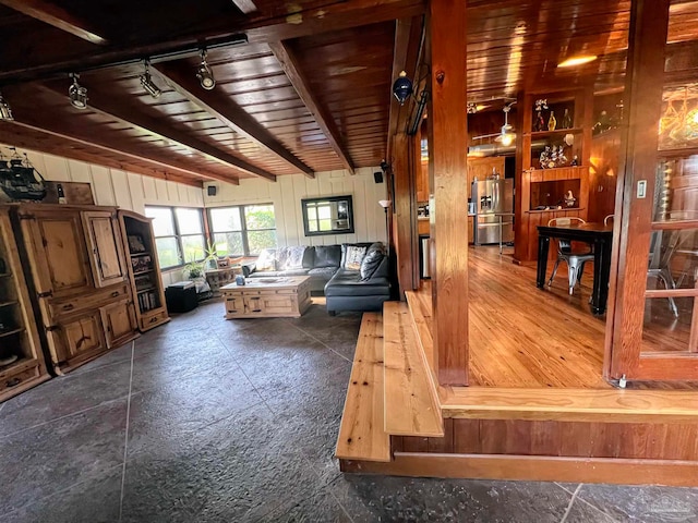 living room with wooden walls and wooden ceiling