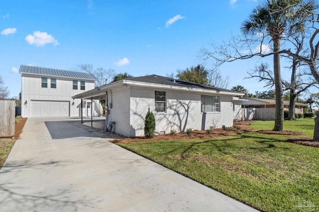 view of front of home with brick siding, a front lawn, fence, driveway, and an attached garage