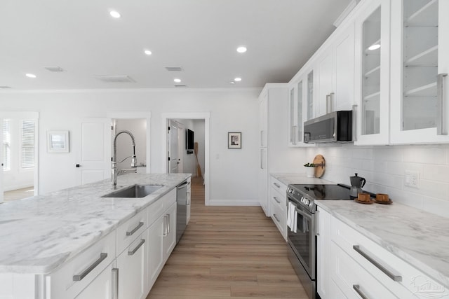 kitchen featuring white cabinetry, crown molding, appliances with stainless steel finishes, and a sink