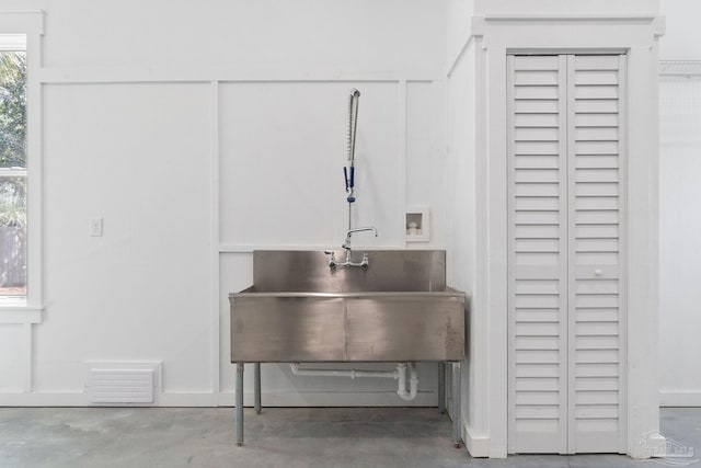 interior space with visible vents, concrete floors, and a sink