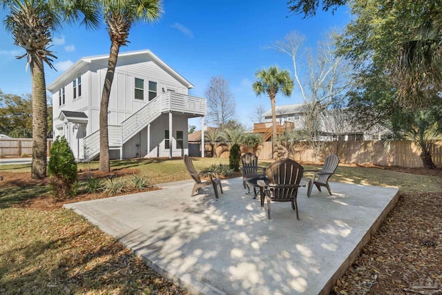 view of patio / terrace featuring stairs and fence