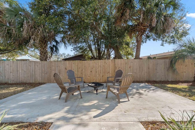 view of patio featuring a fenced backyard and a fire pit