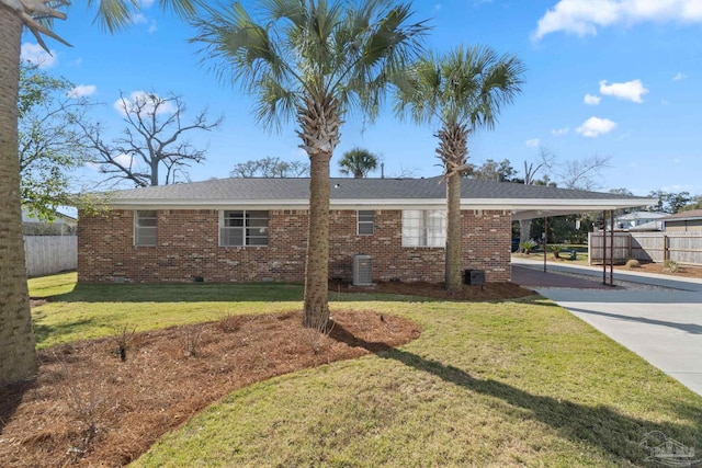 single story home featuring fence, concrete driveway, a front lawn, a carport, and brick siding