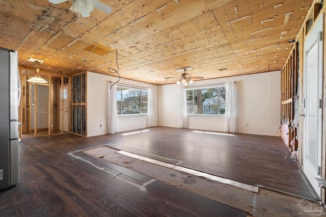 spare room featuring hardwood / wood-style floors, a ceiling fan, and a wealth of natural light