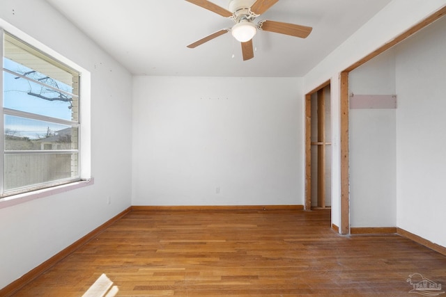 unfurnished bedroom with light wood-style floors, baseboards, and ceiling fan