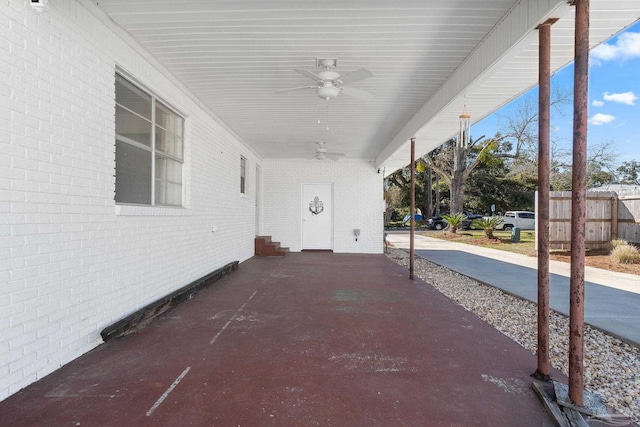 view of patio / terrace featuring a carport, a ceiling fan, and fence