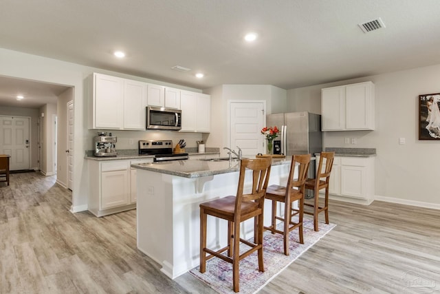 3488 Fallschase Blvd, Pensacola, FL 32526 - kitchen with stainless steel appliances, light wood-style floors, baseboards, white cabinetry, and recessed lighting