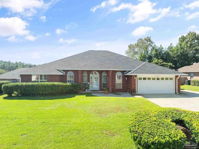 ranch-style home featuring a garage and a front yard