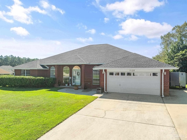 single story home with a garage and a front yard