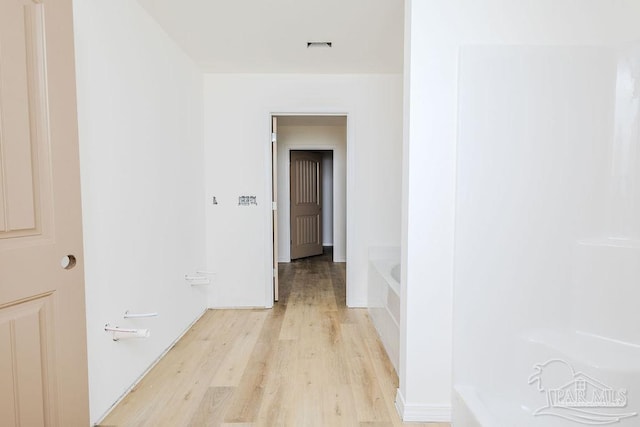 corridor with light wood-style flooring