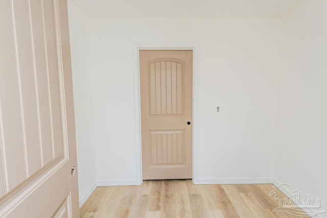 empty room featuring light wood-style flooring and baseboards