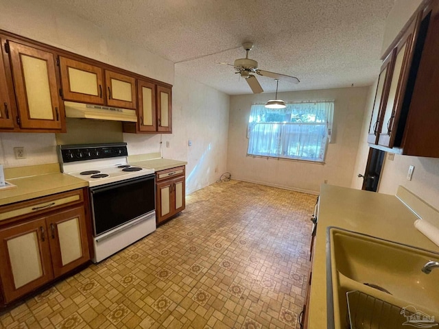 kitchen featuring a textured ceiling, white electric range, ceiling fan, and sink