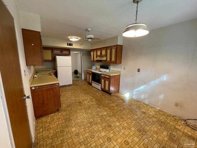 kitchen with a textured ceiling, sink, ceiling fan, pendant lighting, and white appliances