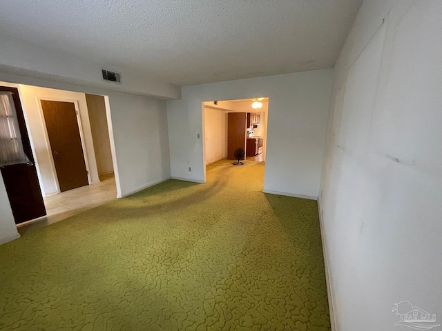 unfurnished room featuring a textured ceiling