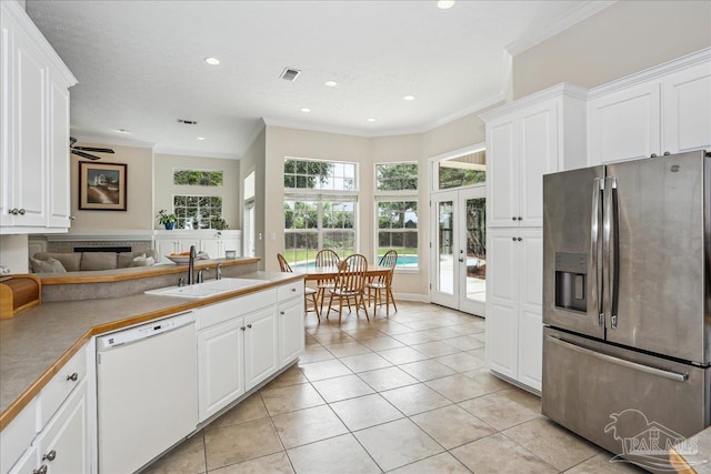 2520 Abbie Elizabeth Ct, Gulf Breeze, FL 32563 - kitchen featuring stainless steel fridge, dishwasher, french doors, crown molding, and light tile patterned floors