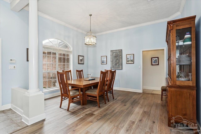 2520 Abbie Elizabeth Ct, Gulf Breeze, FL 32563 - dining space with decorative columns, wood finished floors, a chandelier, and crown molding