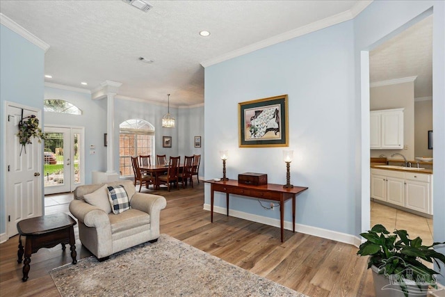 2520 Abbie Elizabeth Ct, Gulf Breeze, FL 32563 - living room featuring light wood finished floors, crown molding, and recessed lighting