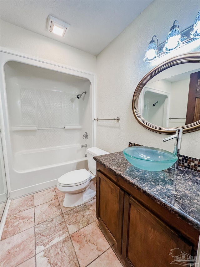 bathroom featuring tub / shower combination, vanity, and toilet