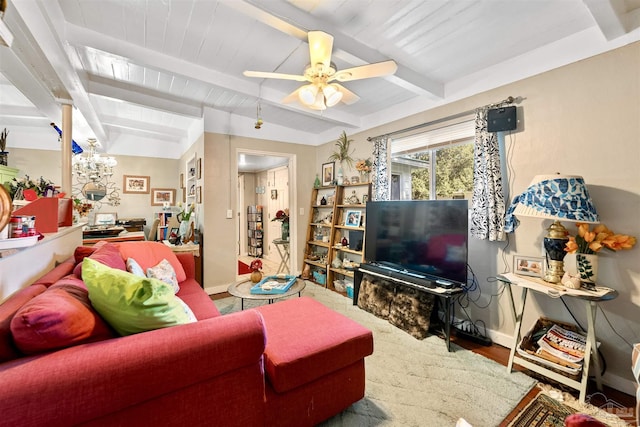 living room featuring a ceiling fan, beam ceiling, baseboards, and wood finished floors