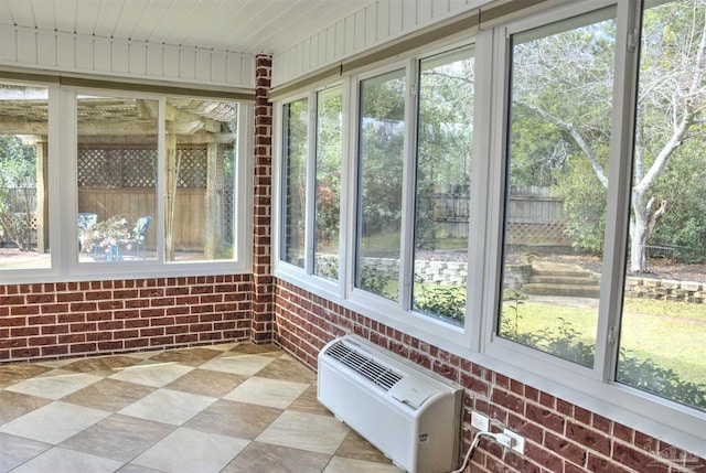 unfurnished sunroom featuring a wall mounted air conditioner