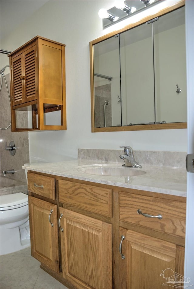 bathroom with vanity, tile patterned floors, and toilet