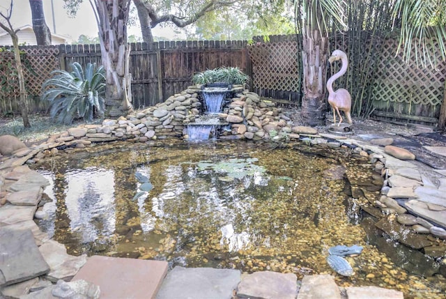 view of yard with a garden pond