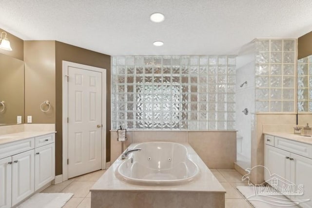 bathroom featuring vanity, plus walk in shower, a textured ceiling, and tile patterned floors