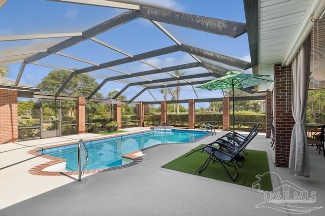 view of swimming pool with glass enclosure and a patio area