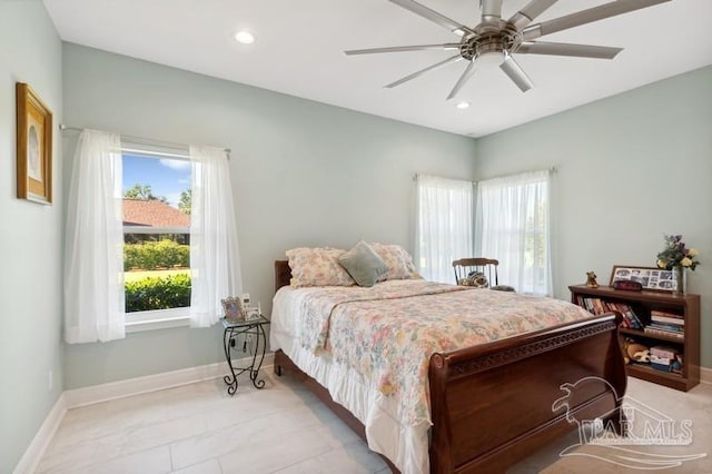 tiled bedroom featuring ceiling fan